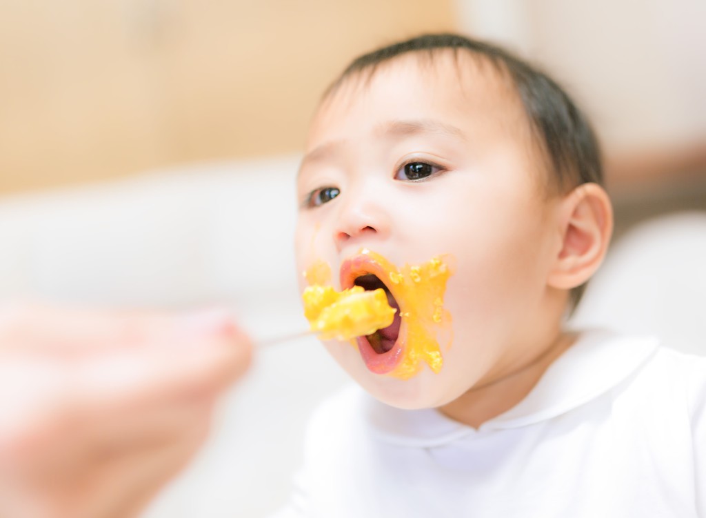 ご飯を食べさせてもらっている赤ちゃん