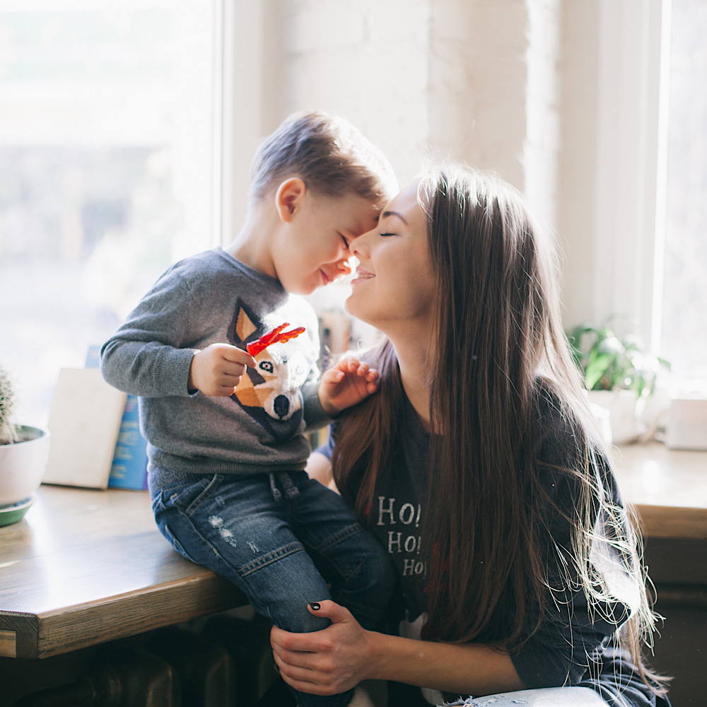 mother kissing her little son